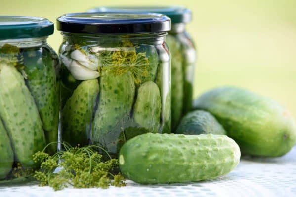 Jars of pickles and cucumbers beside them illustrating Prescott’s Pickle Principle